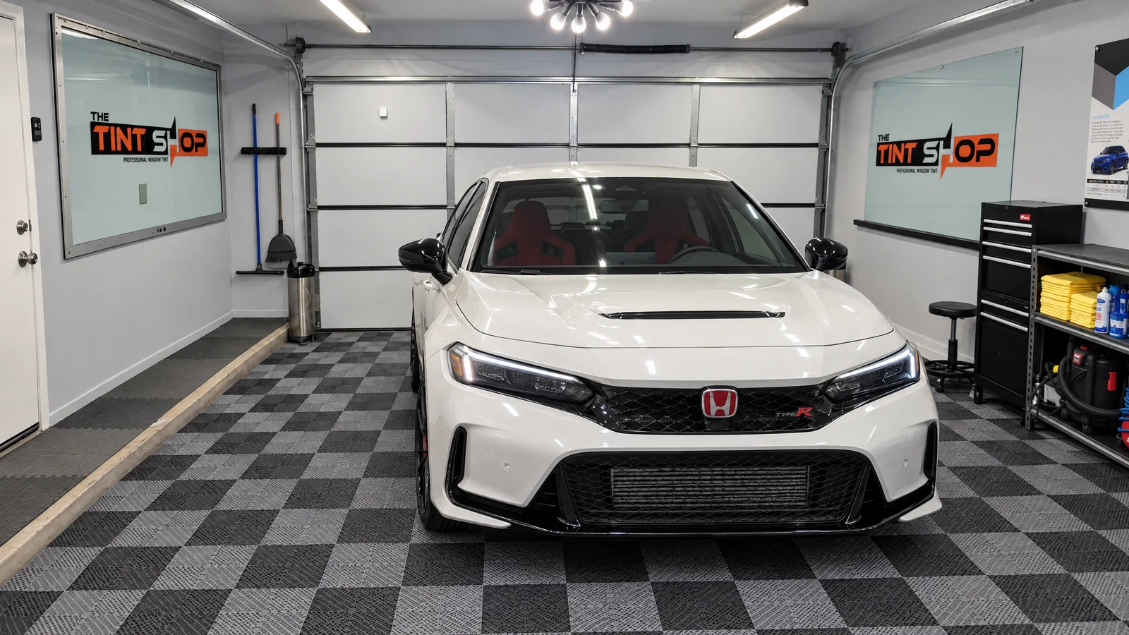 A white Honda Civic Type R with tinted windows in The Tint Shop’s Phoenix workspace